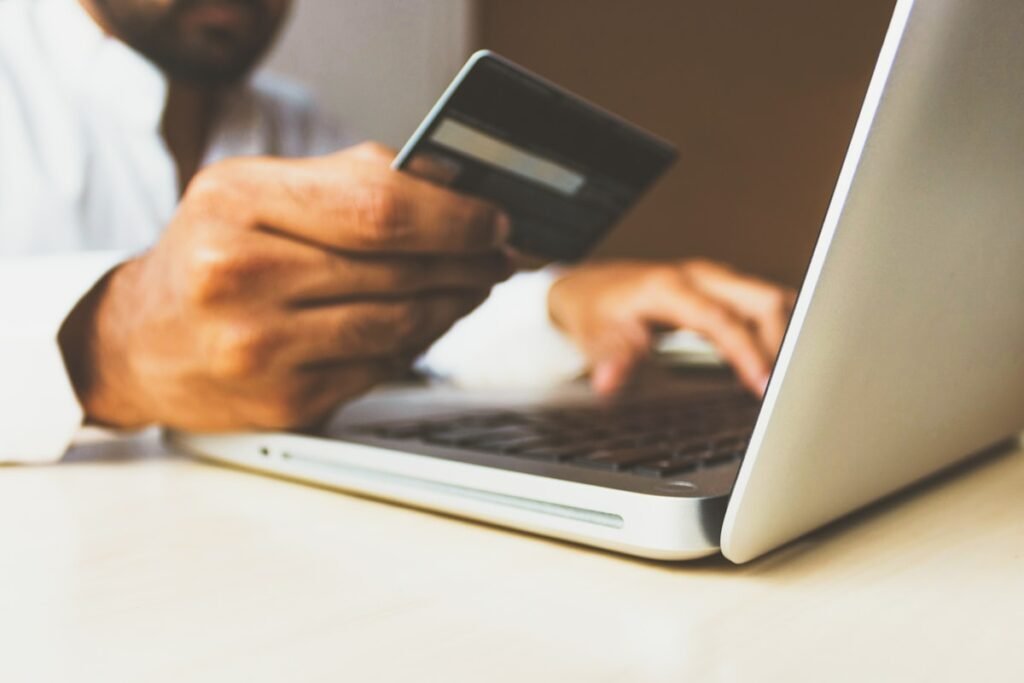 Credit card and laptop, redeeming points for a free flight from Canada